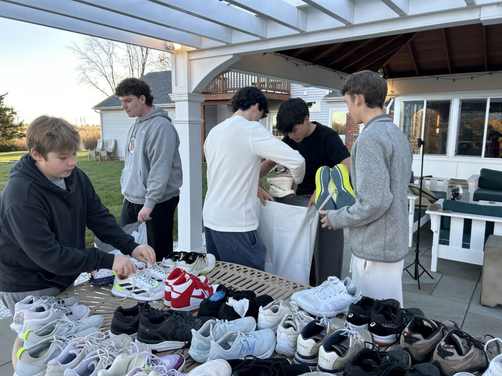 Teen volunteers collecting donated sneakers to support families at Ronald McDonald House of Connecticut