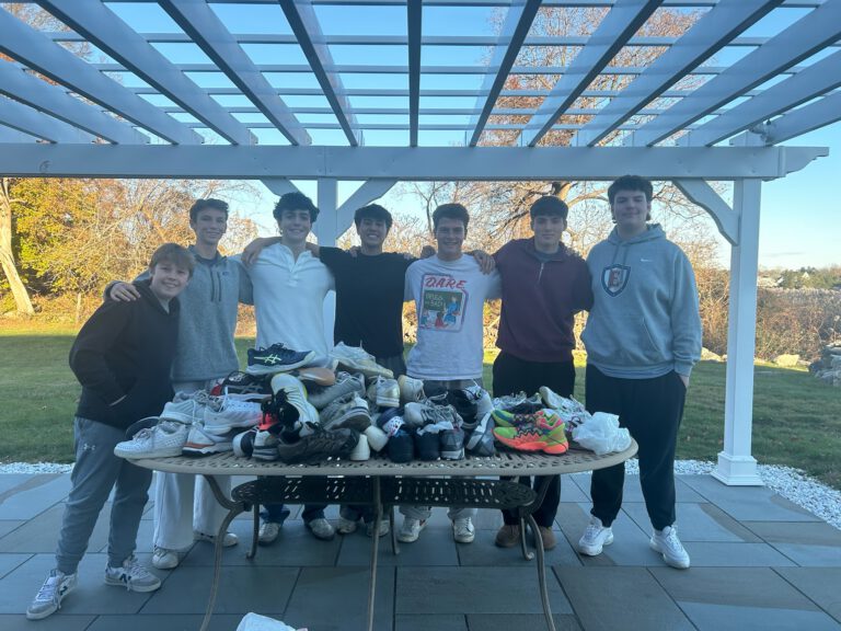 Teen volunteers collecting donated sneakers to support families at Ronald McDonald House of Connecticut